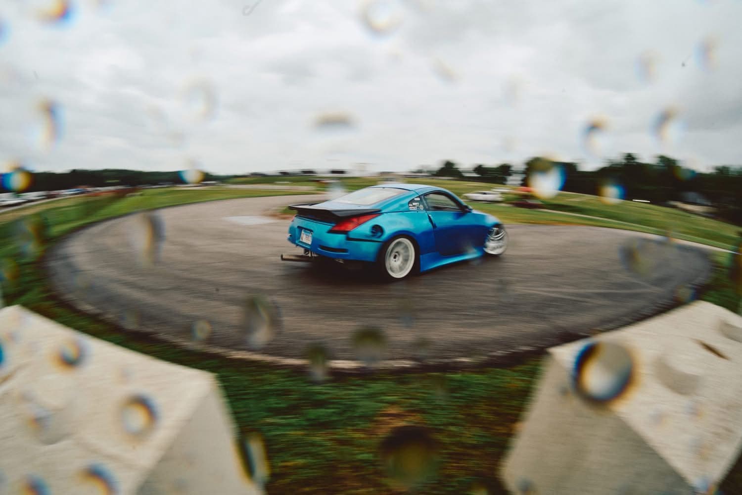 Blue 350Z drifting in the rain