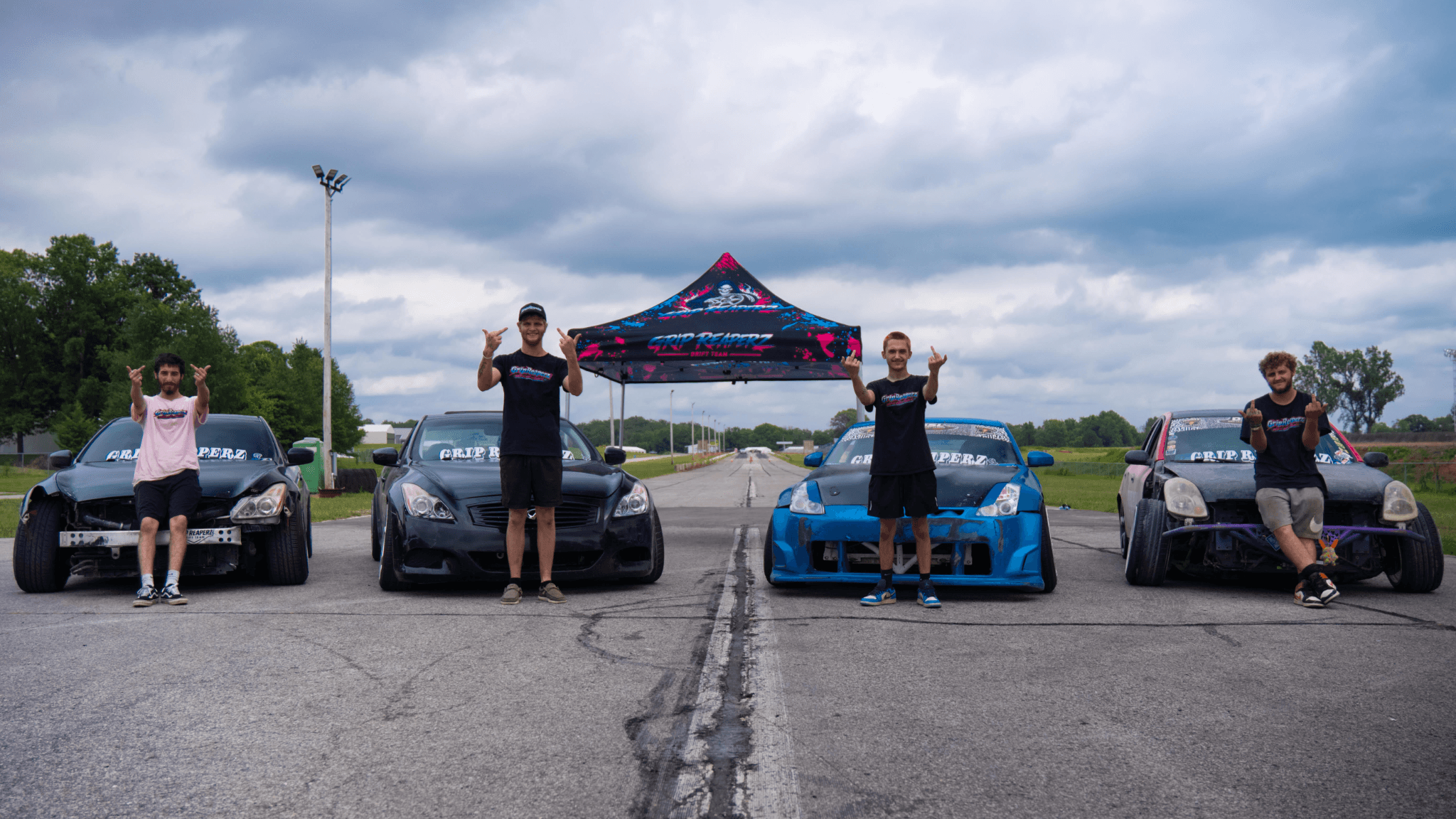 The four GripReaperz drivers with their cars and matching team tent